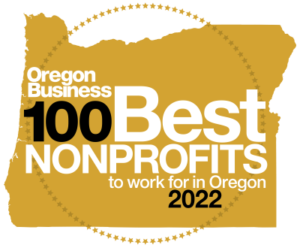 A gold circle with the words oregon business 100 best nonprofits to work for in oregon 2022.
