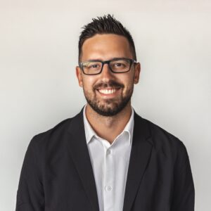 Man wearing suit and glasses headshot. SOA Board member