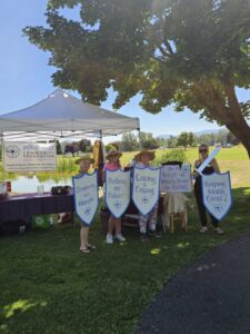 People holding signs at a community event.