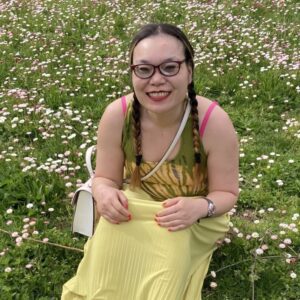 women smiling in the grass and flowers