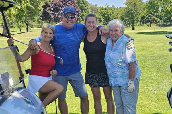 Group enjoying a sunny day golfing.